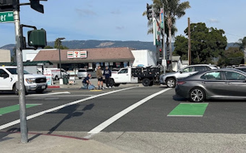 Bystanders Help Man Lying in Center of Hollister Avenue in Old Town Goleta